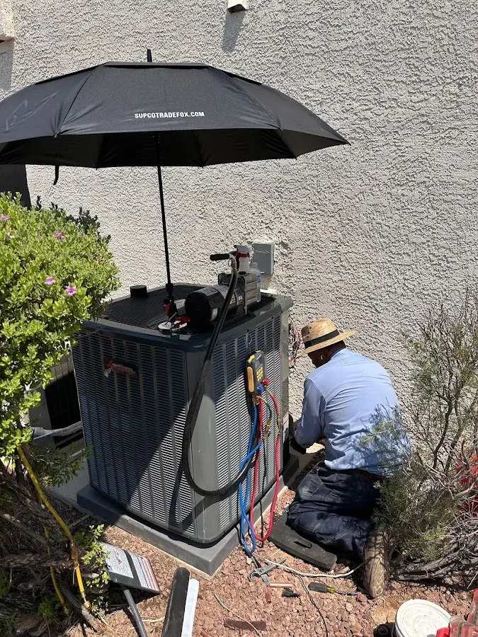HVAC technician performing outdoor AC maintenance in Lincoln